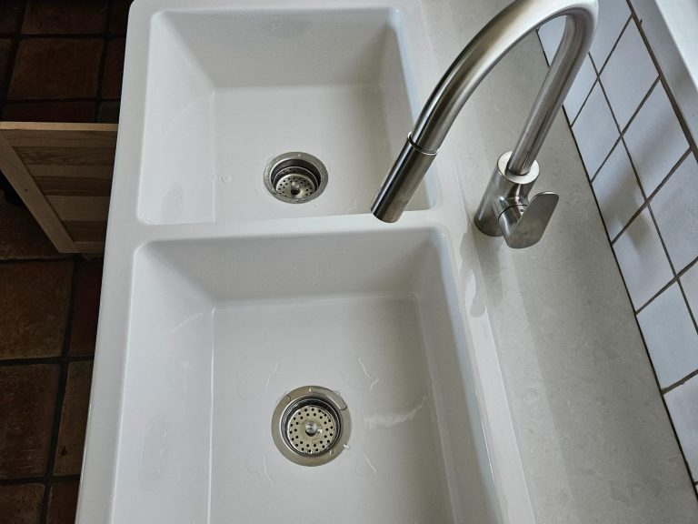 Double-basin kitchen sink with faucet