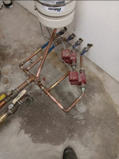 Copper piping and circulation pumps Copper pipe connections and red circulation pumps
