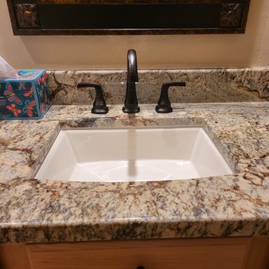 Bathroom sink and faucet Bathroom sink with a black faucet and stone countertop