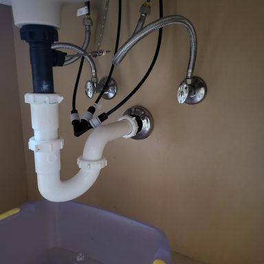 Sink drain and supply plumbing Under-sink P-trap and supply connections