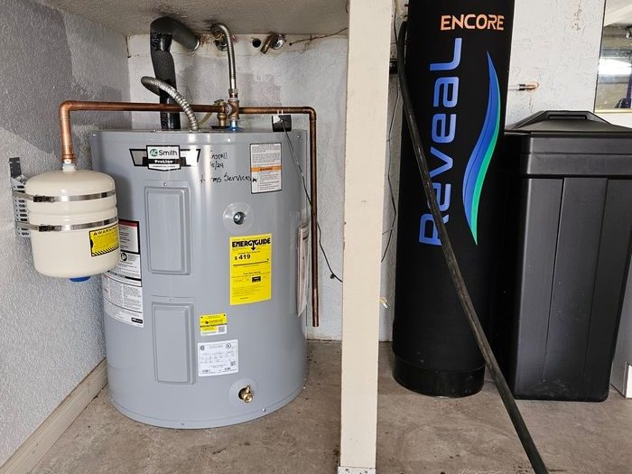 Harms Services water heater and water treatment photo Water heater, expansion tank, copper piping and water-treatment equipment.