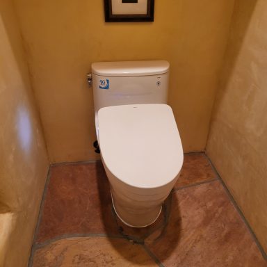 Bathroom toilet installation Toilet installed in a tiled bathroom alcove