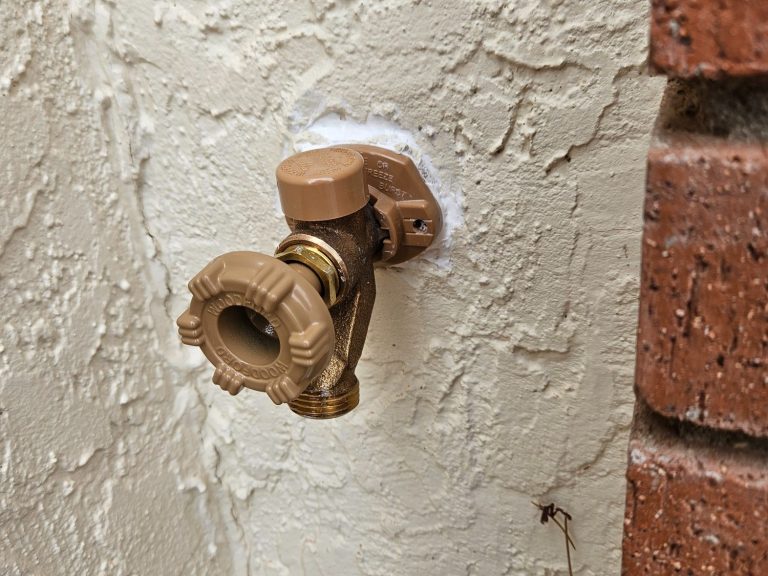 Exterior plumbing fixture project Exterior hose bib mounted on a stucco wall