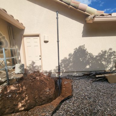 Exterior water line work Exterior trench along a home near a hose connection