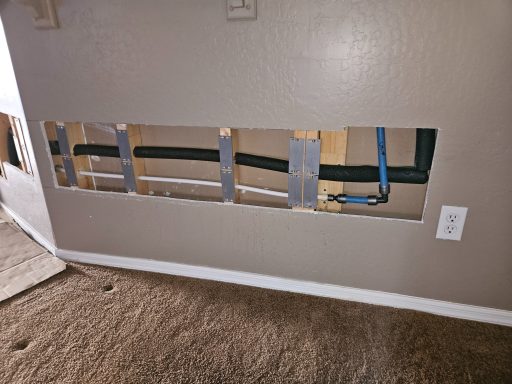 Plumbing access in an interior wall Open lower wall section exposing plumbing lines